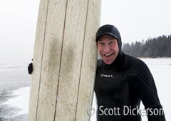 Vince Tillion smiles after a snowy winter surf session in Alaska.