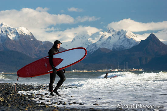 Brad Conley heads out for a fall surf in Homer, Alaska.