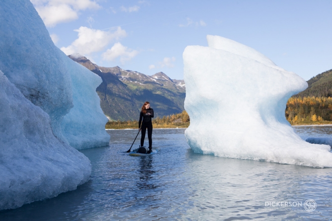 stand up paddling by icebergs at spencer glacier in Alaska